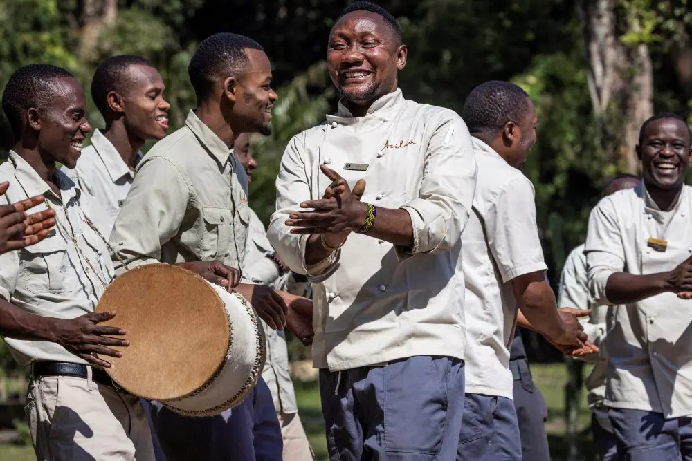 The staff of Rubondo Island Camp provide a joyous welcome on the beach.