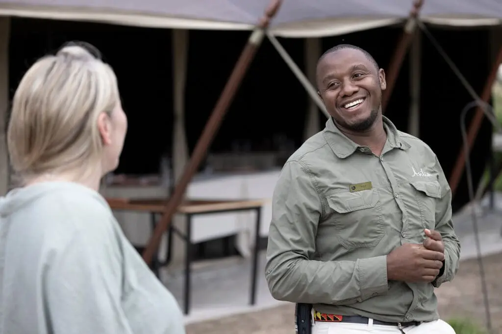 Serengeti National Park female solo traveller having a chat with camp staff member