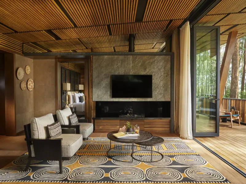 One Only Gorilla's Nest Guest suit interiors, balcony with forest view, lounge area with television and seating