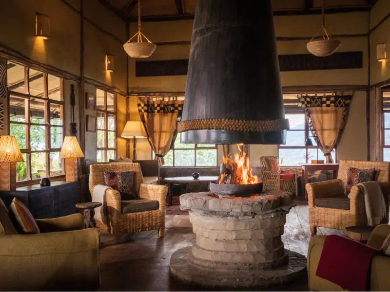 Volcanoes Virunga Lodge indoor lounge area with firepit in the centre and seating