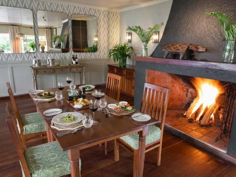 Wilderness Sabyinyo dining setup near the fireplace