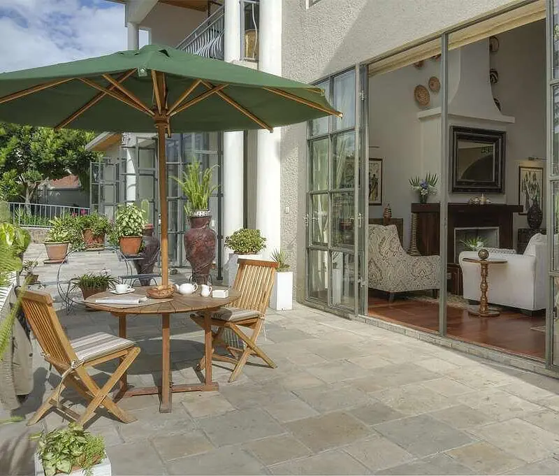 Bishop's House dining on the patio with umbrella for shade