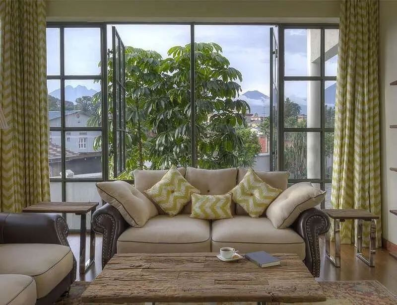 Bishop's House Lounge interior with a view, bookshelf and couches with throw pillows