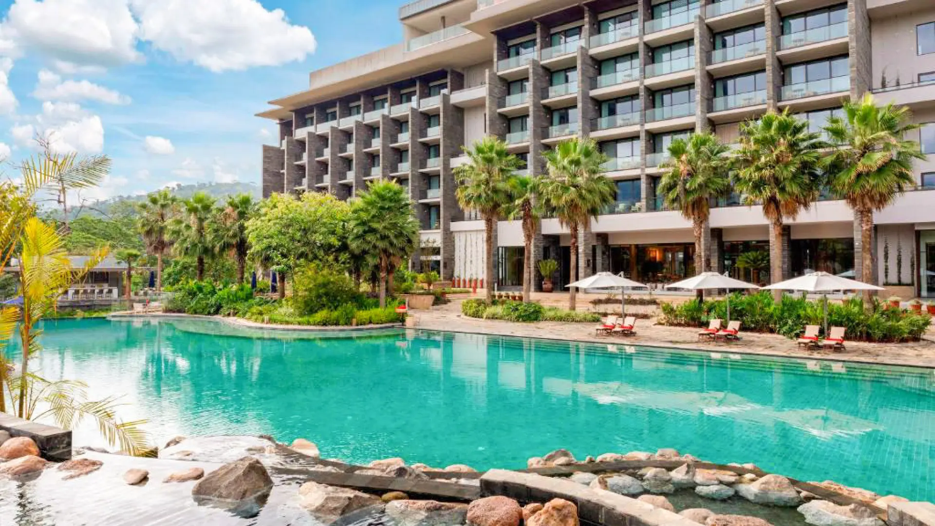 A view of the expansive swimming pool in front of the Gran Melia Arusha.