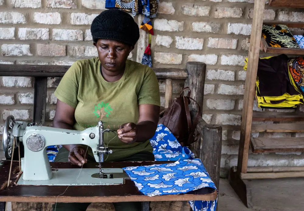 Mama Faith working with a pedal powered sewing machine, Bwindi, Uganda.