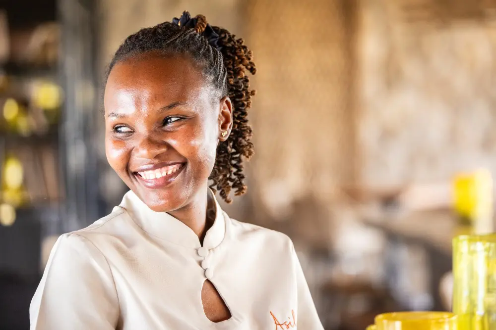 A smiling staff member at Namiri Plains, Tanzania