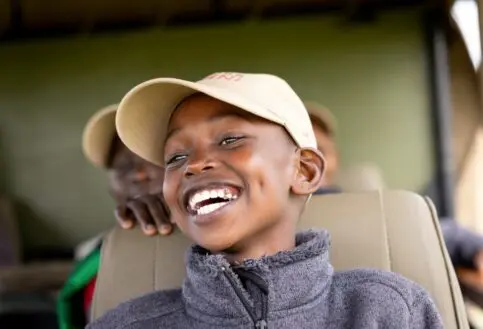 A child smiling with excitement at Twende Porini, Kenya.