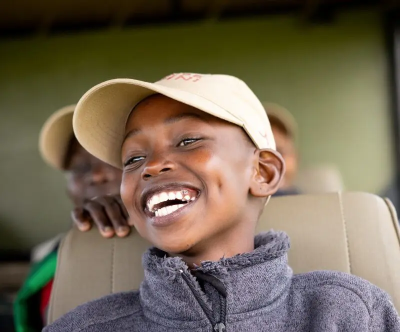 A child smiling with excitement at Twende Porini, Kenya.