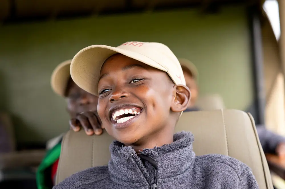 A child smiling with excitement at Twende Porini, Kenya.