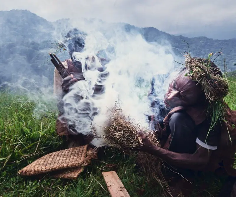 Preparing smoke ahead of the collection of honey, Bwindi, Uganda.