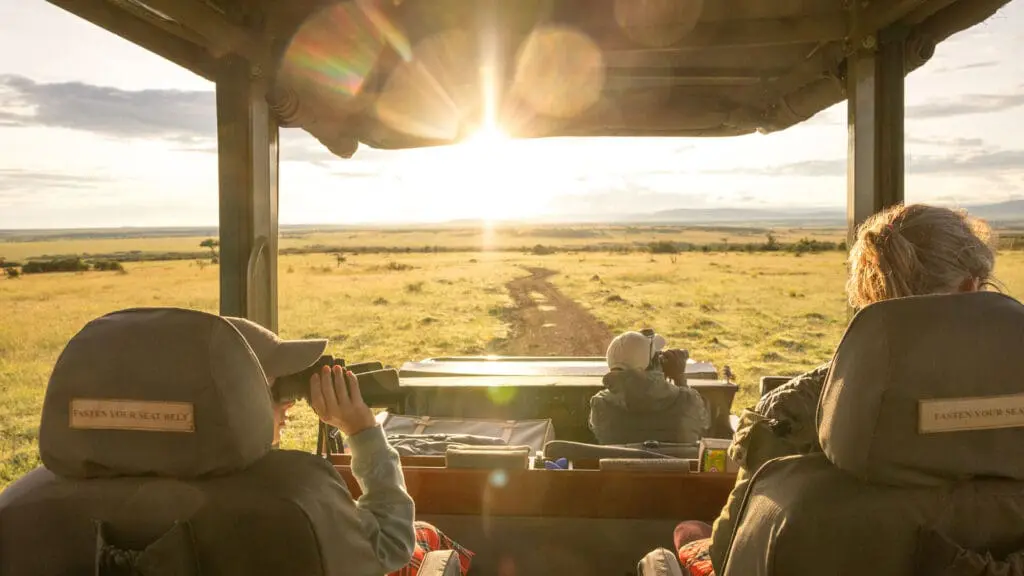Guests watching sunrise at Naboisho Camp in the Masai Mara