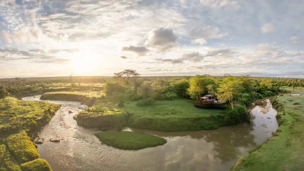 Aerial view of Ol Pejeta Bush Camp nestled between the trees surrounded by Ewaso Ng'iro River