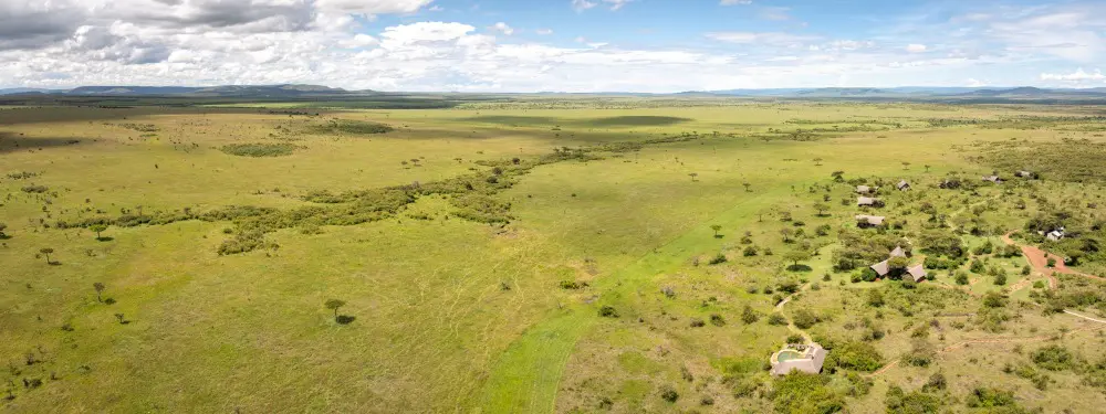 Naboisho Camp and the open plains of the Mara Naboisho Conservancy, Kenya.