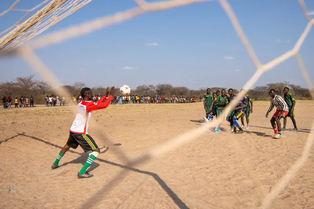 The goalkeeper makes a save during the Tembo Cup, southern Tanzania.