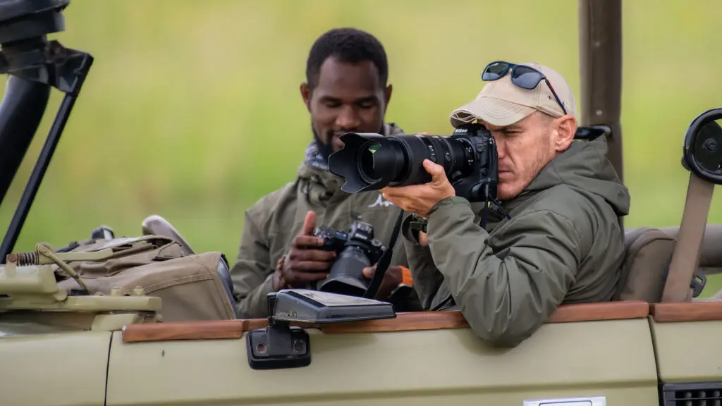 A guest taking a photo from a safari vehicle, Tarangire National Park.
