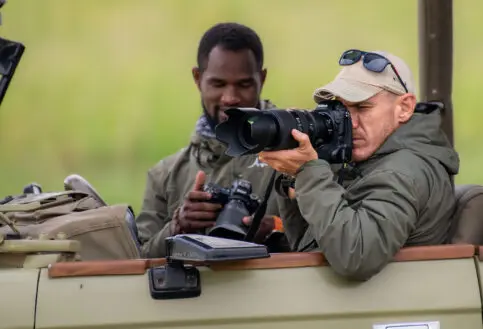 A guest taking a photo from a safari vehicle, Tarangire National Park.