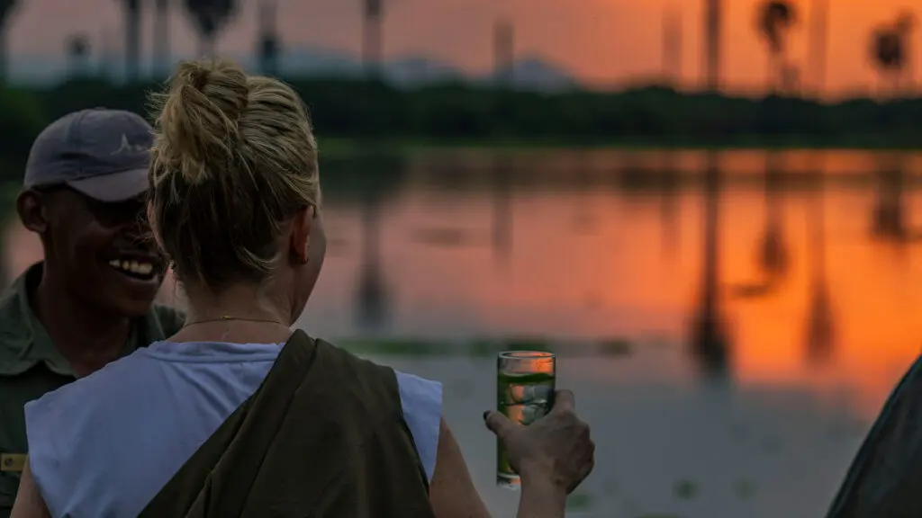 Asilia Guest Enjoying a Sundowner at Roho Ya Selous