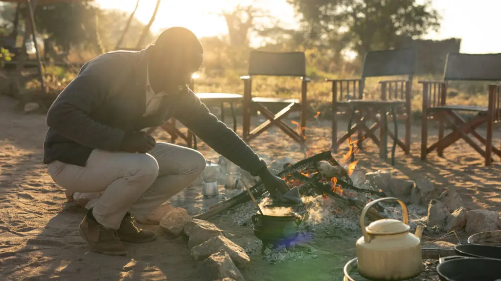 Asilia staff lighting the camp fire