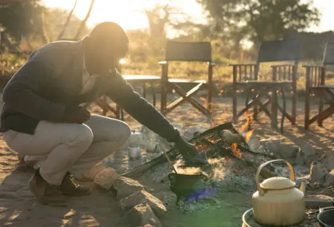 Asilia staff lighting the camp fire