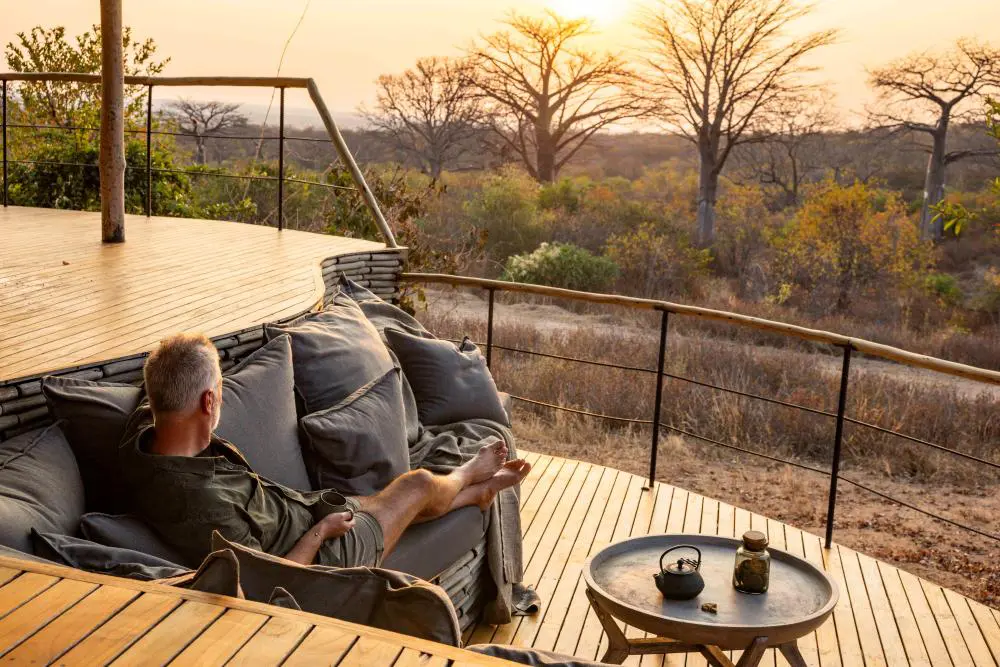 A guest enjoys the private outdoor lounge at Jabali Ridge, Ruaha National Park.