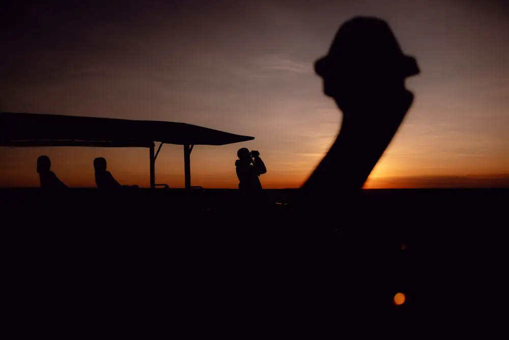 Daniel stands surveys the landscape in the first morning light, Serengeti.