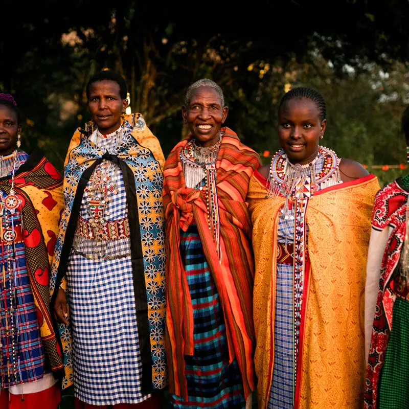 a group of ladies from the Maasai Mara community stand together