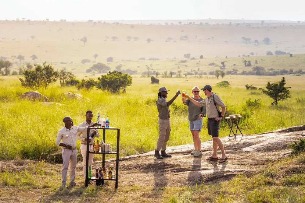 Guests enjoying sundowners in the Serengeti National Park, Tanzania.
