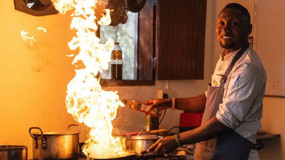 Chef cooking with fire, Rubondo Island, Tanzania.