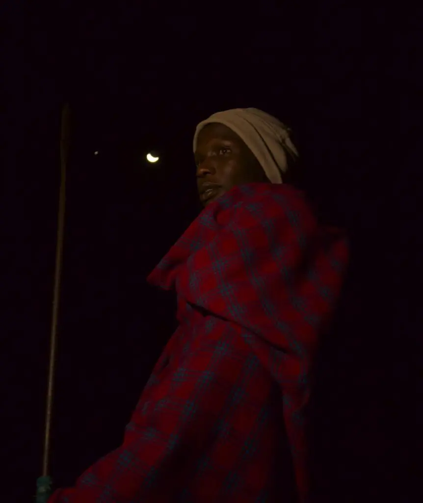 An Askari keeps watch wearing the characteristic Maasai shuka fabric