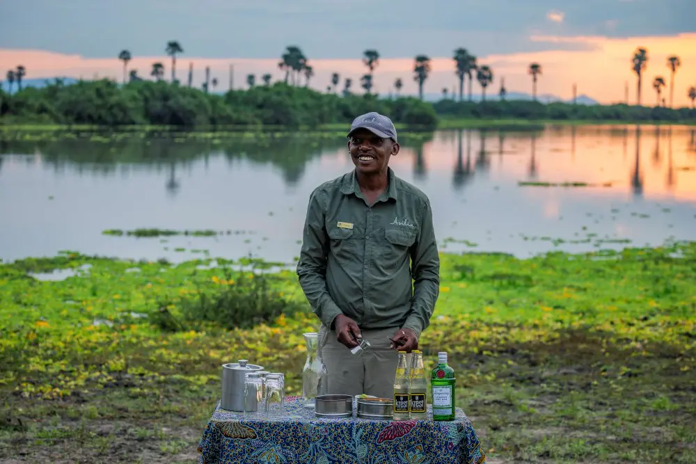 A sundowner setup on the water's edge, Nyerere National Park, Tanzania.