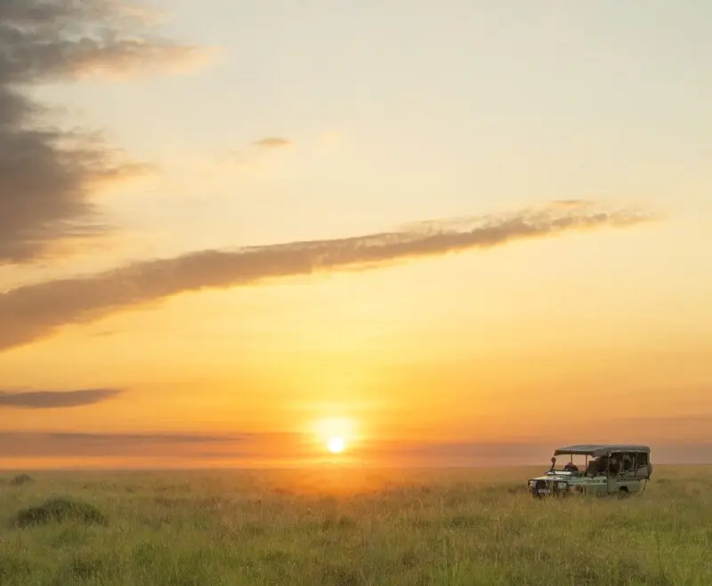 A lone vehicle on the plains at sunset, Mara Naboisho Conservancy, Kenya