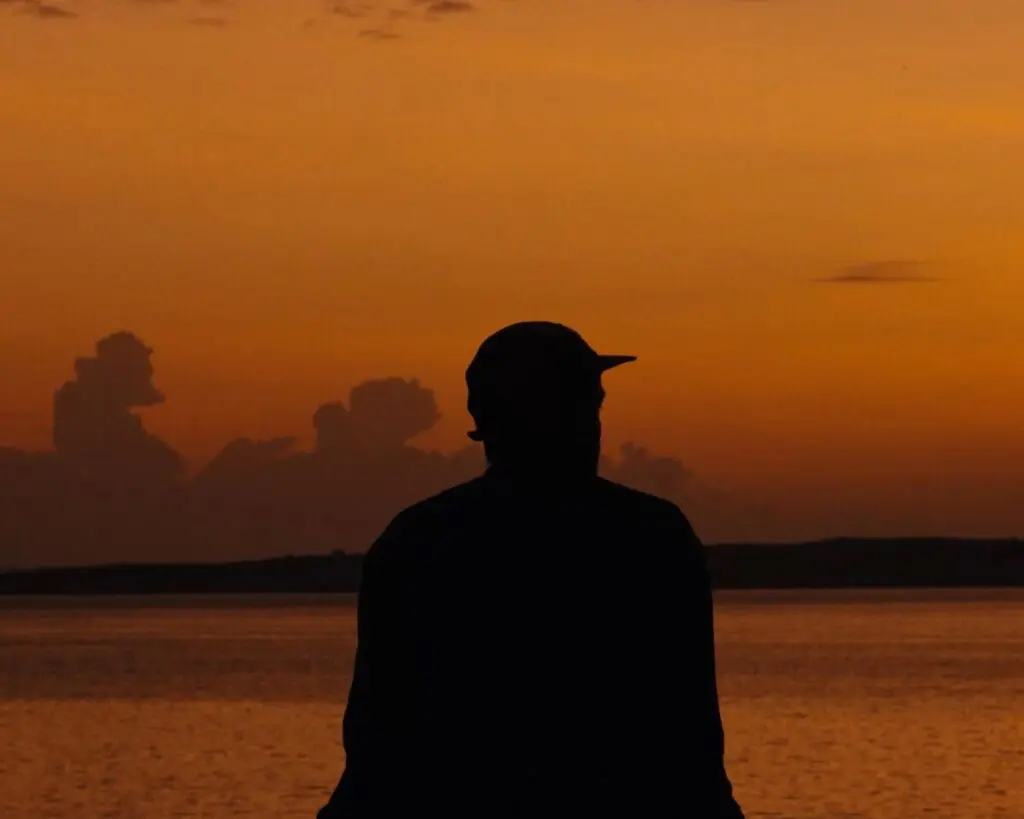 Asilia guest enjoying views of Lake Victoria during sunrise at Rubondo Island Camp, Tanzania.