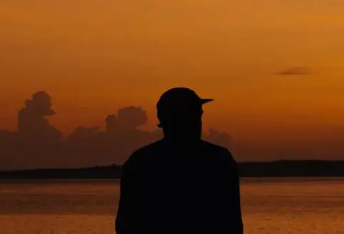 Asilia guest enjoying views of Lake Victoria during sunrise at Rubondo Island Camp, Tanzania.