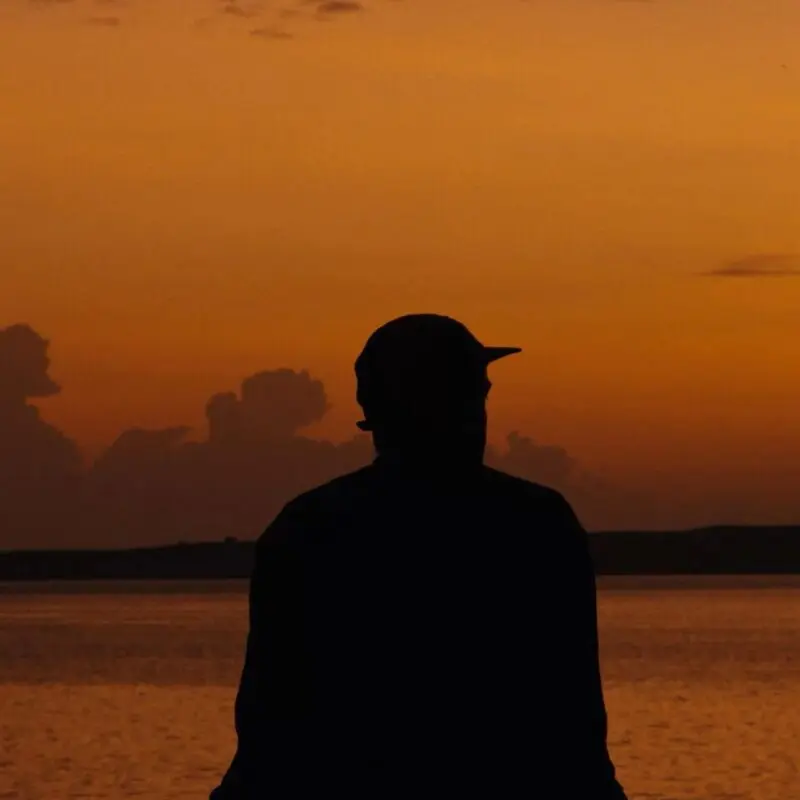 Asilia guest enjoying views of Lake Victoria during sunrise at Rubondo Island Camp, Tanzania.