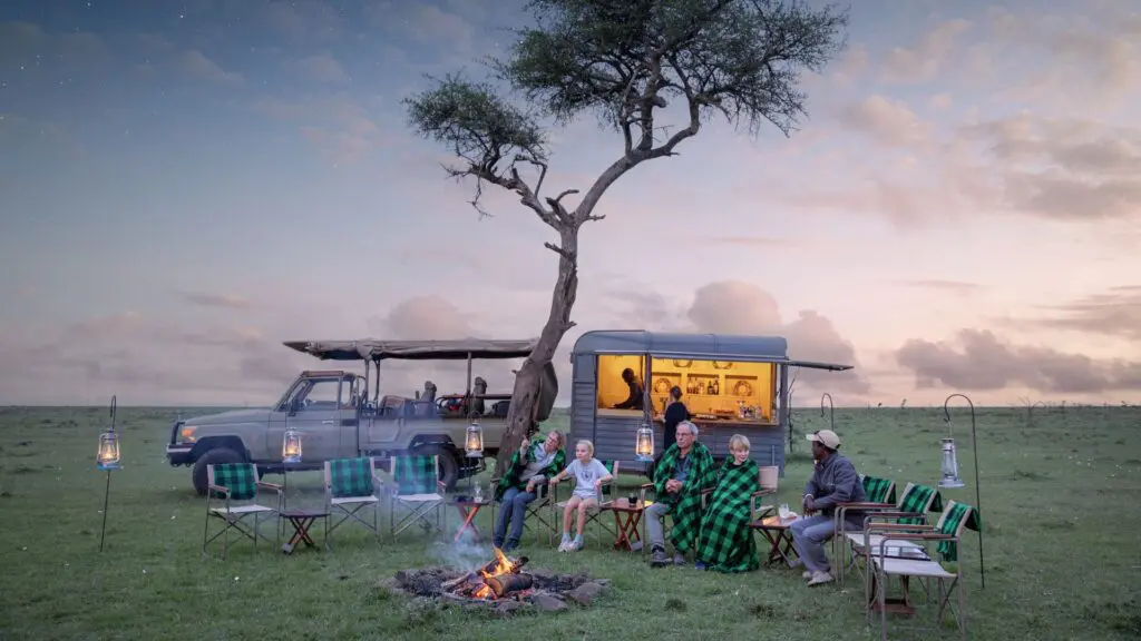a family at the fireside at sunset