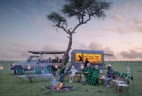 a family at the fireside at sunset