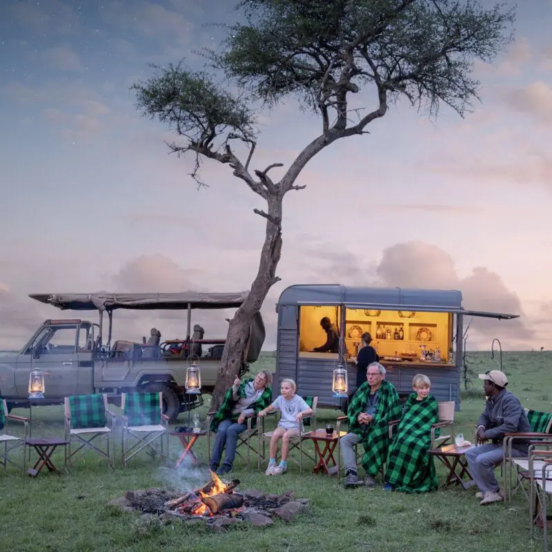 a family at the fireside at sunset