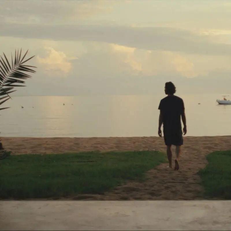 Asilia guest enjoying a stroll on the sandy shores of Rubondo Island
