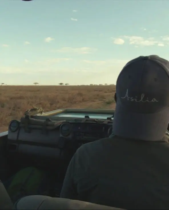 Asilia guide driving down the dusty road of the Serengeti National Park.