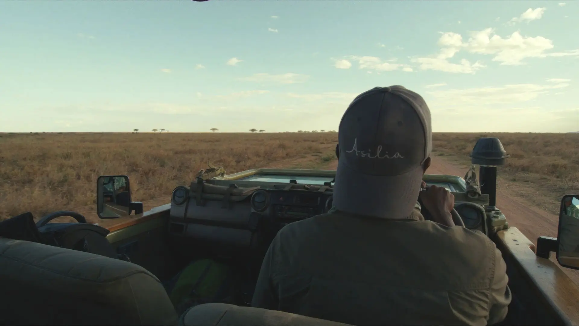 Asilia guide driving down the dusty road of the Serengeti National Park.