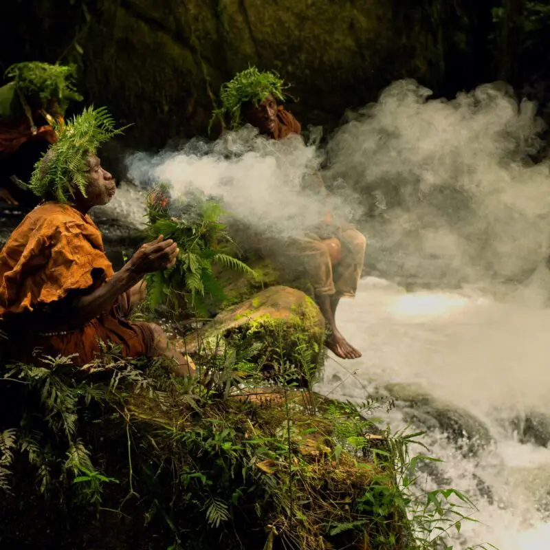 The Batwa burning leaves for protection during a forest walk.