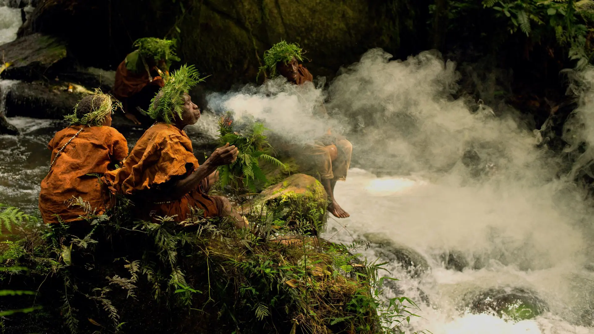 The Batwa burning leaves for protection during a forest walk.