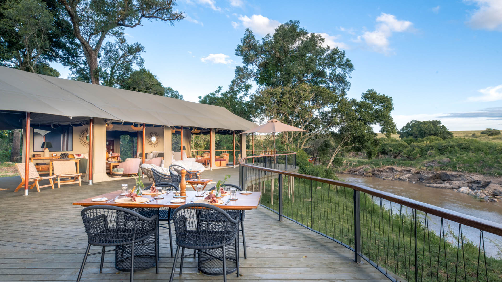 Adining set up on the spacious wooden deck at Rekero shows how close the river is