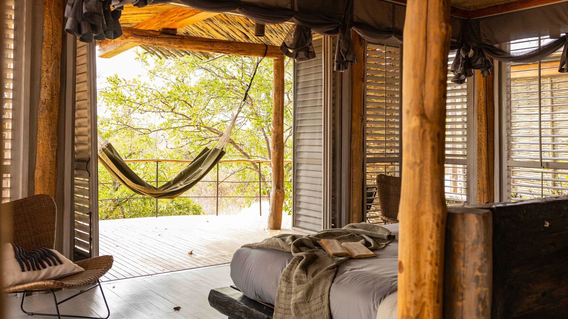 Jabali Private House, hammock swaying on a deck through open shutter doors