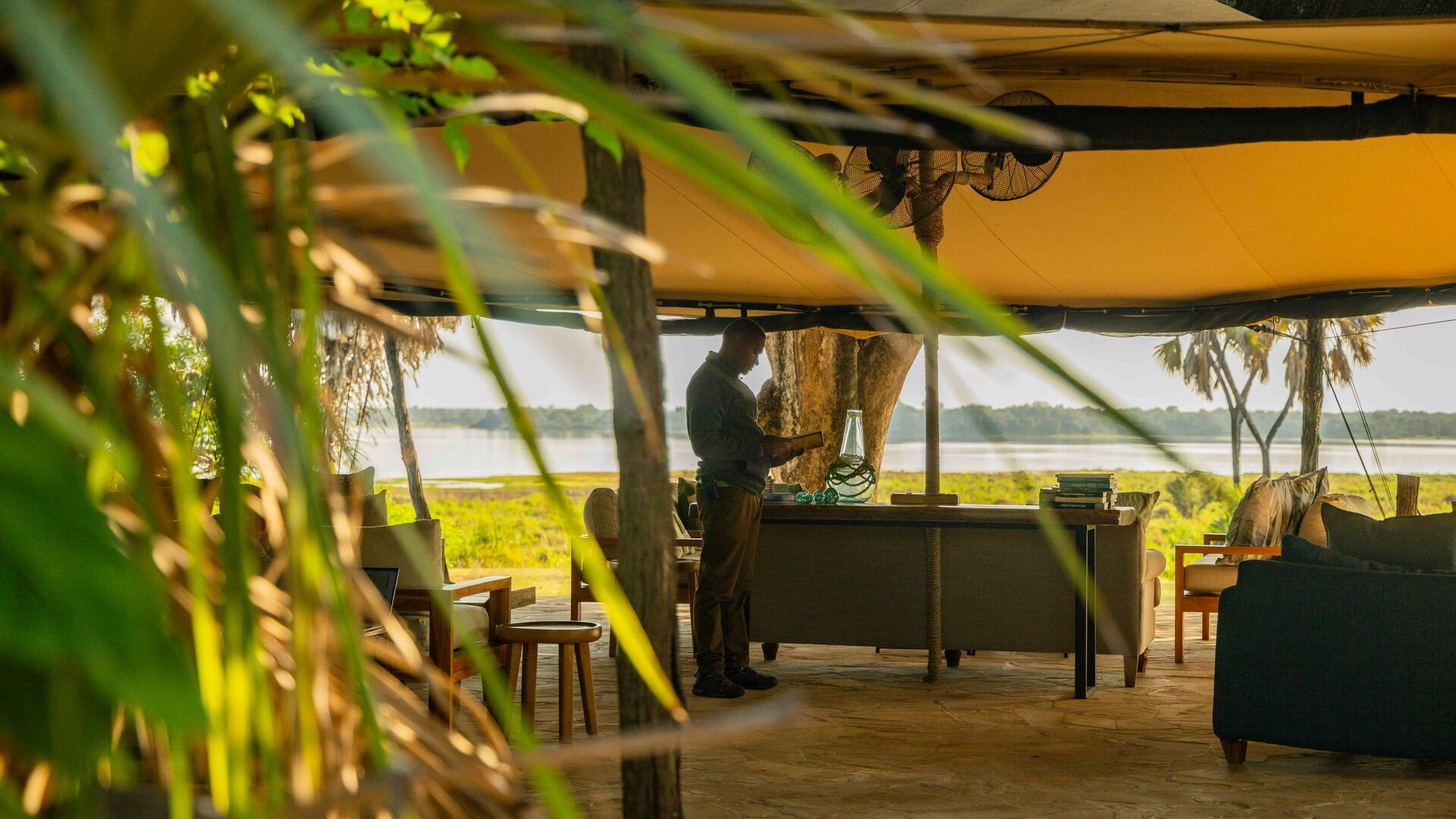 Roho ya Selous' open lounge area with seating facing the river and green landscape