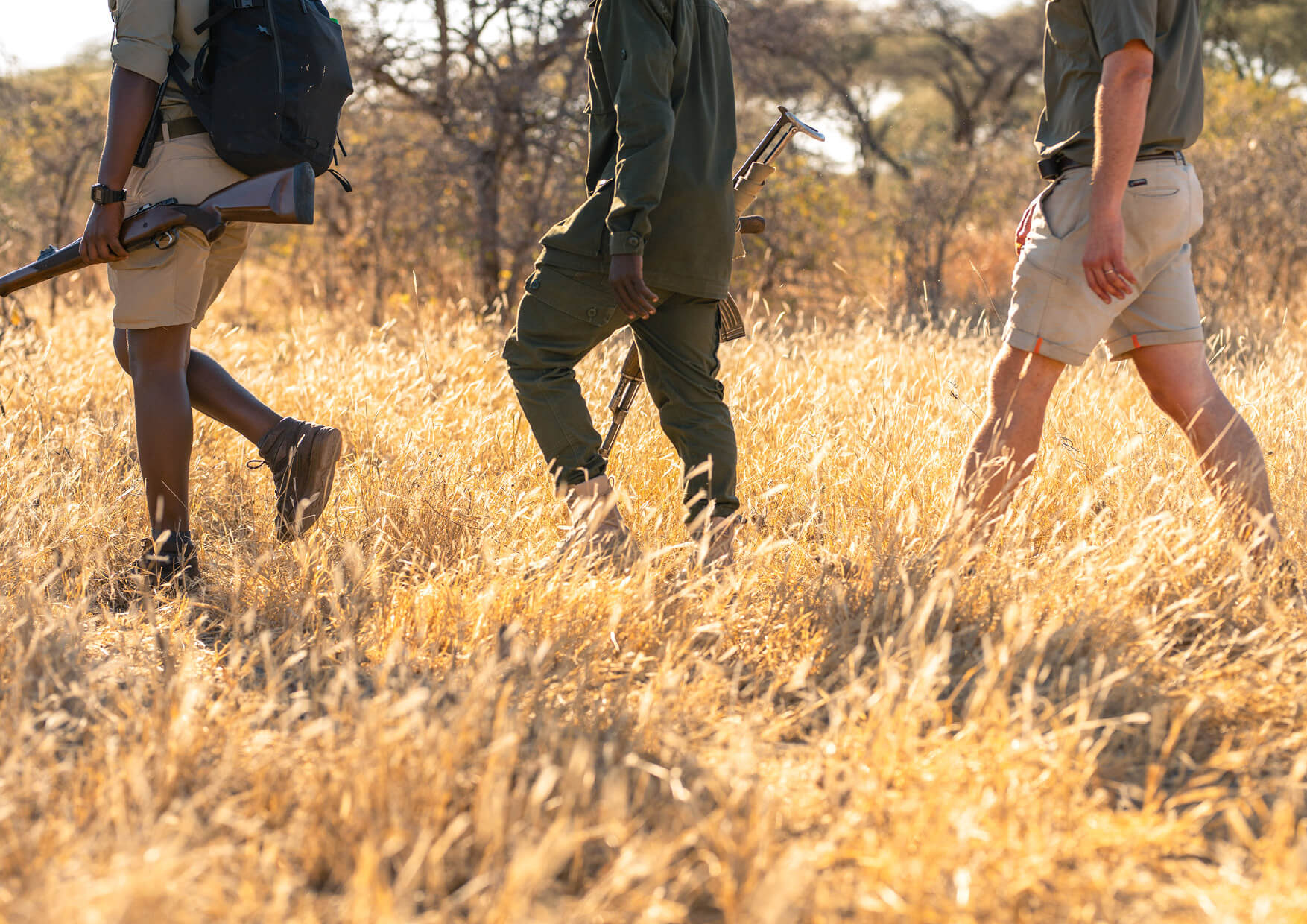 close up of three people on an Asilia Africa walking safari in Tanzania