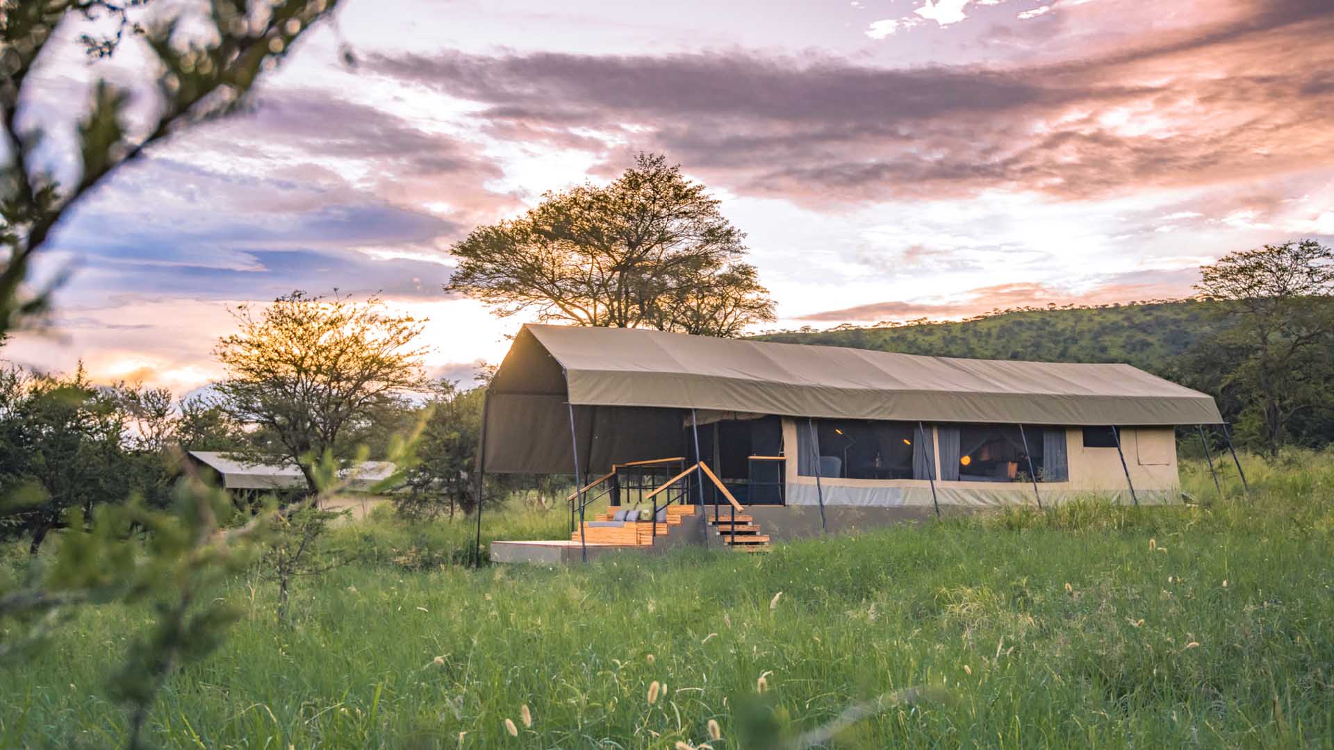 View of Dunai camp guest tents at sunset in the Serengeti