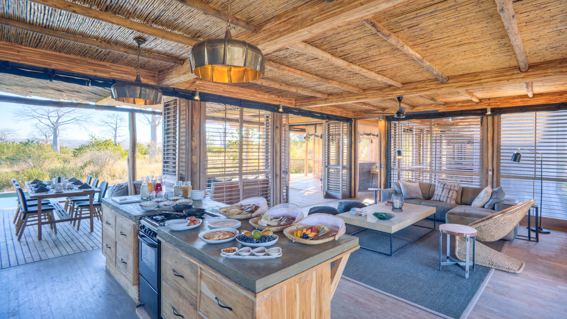 Jabali Private House, Ruaha National Park, kitchen with breakfast setup next to the lounge area and leading on to the deck with shutter doors open