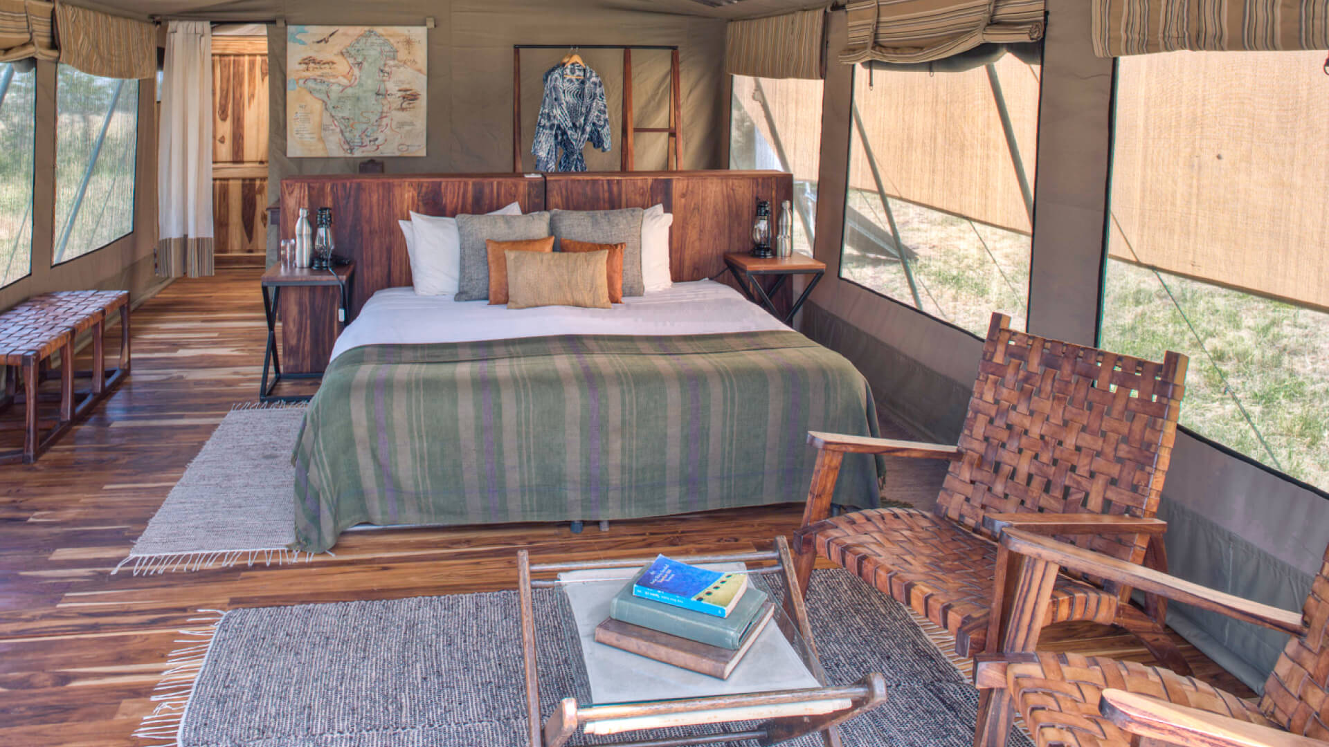 Asilia olakira migration Camp, inside guest tent, bed and chairs, Serengeti National Park, Tanzania