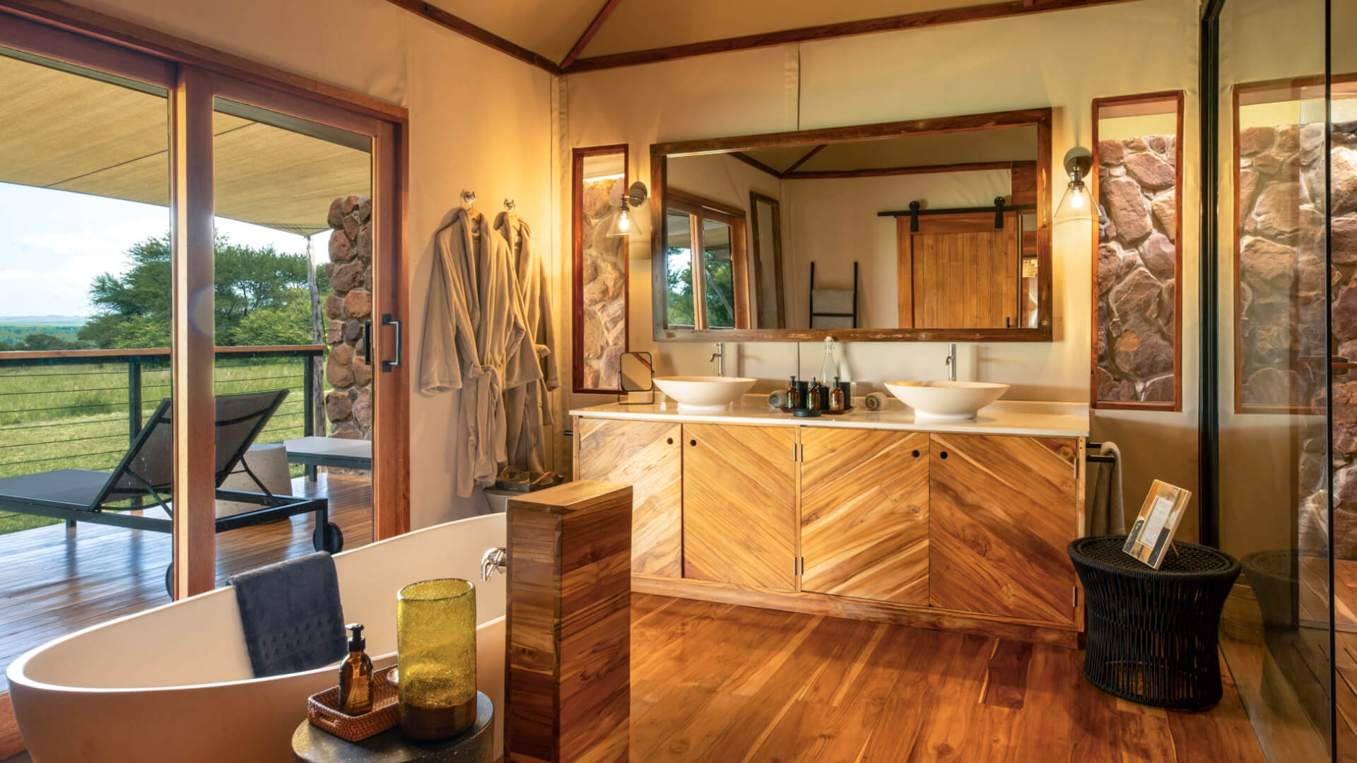 Sayari Retreat, Serengeti National Park, guest bathroom with bath, mirror, dressing gowns, and amenities, double vanity with lights